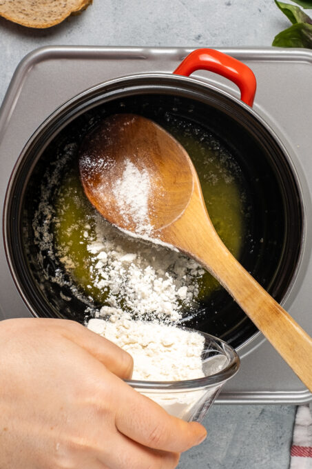 女人的手我们的面粉到锅融化黄油。