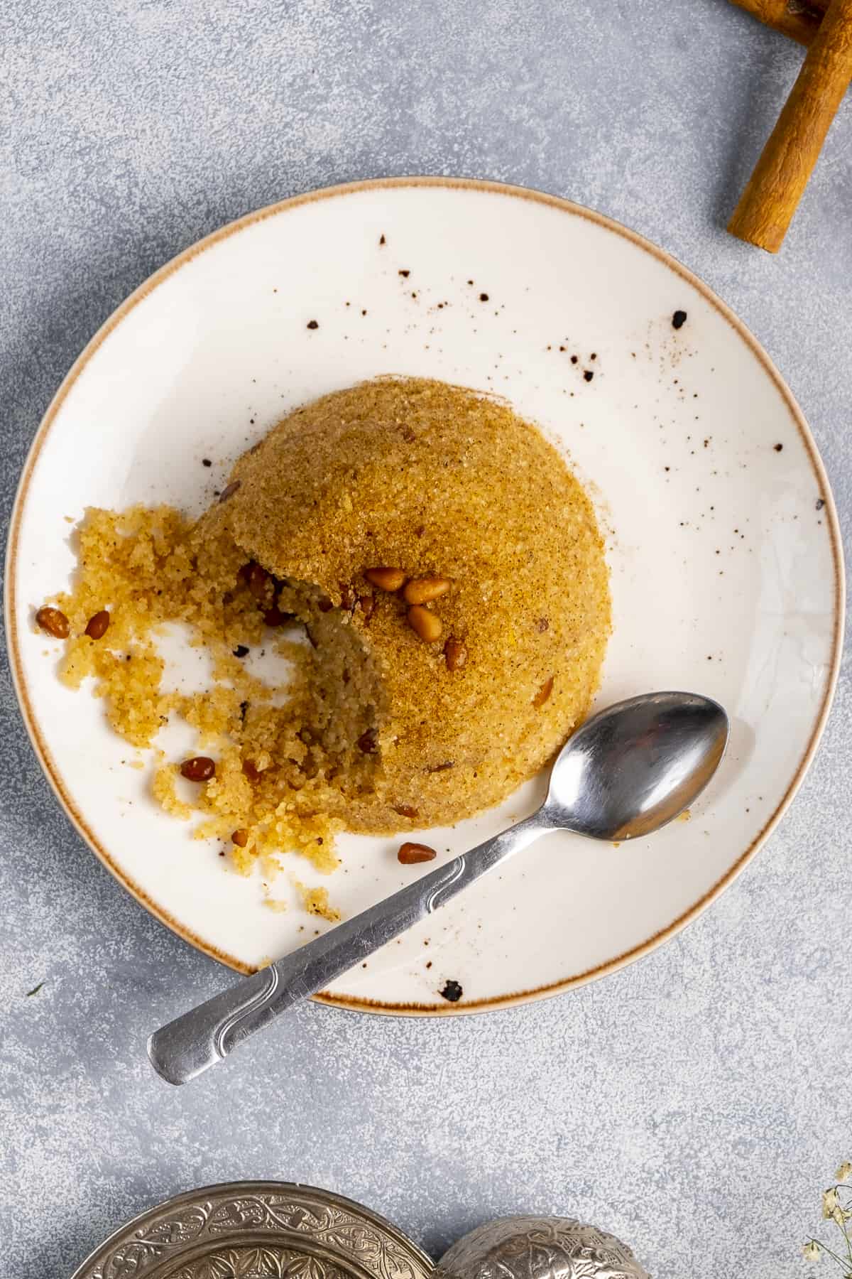 Semolina halva on a white plate pictured from top view.