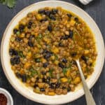 Black bean lentil soup in a white bowl.