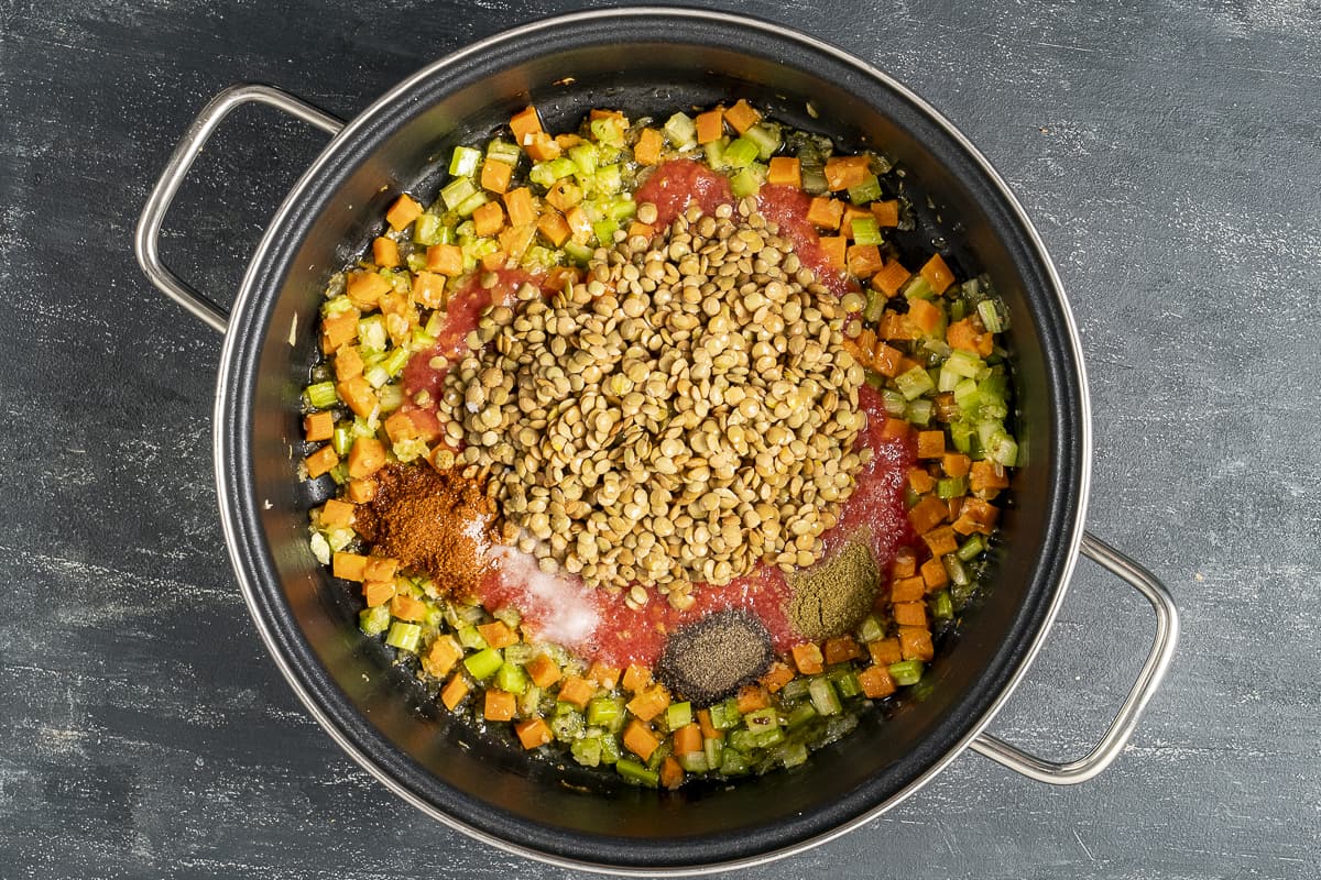 Green lentils and vegetables in a pan.