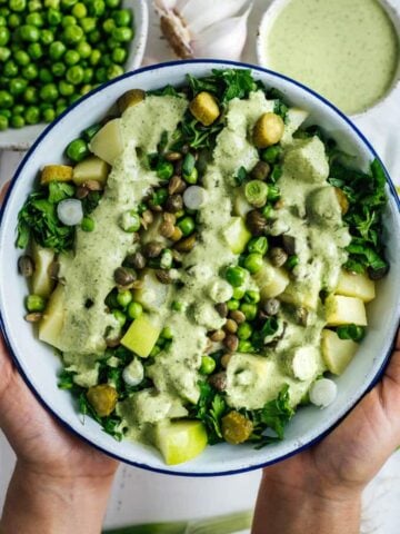 素食土豆沙拉配上绿色小扁豆和清爽的奶油芝麻酱，味道和营养都很丰富。它会让你的晚宴或聚餐更上一层楼。